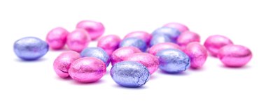 Chocolate easter eggs in pink and lilac foil; isolated on white clipart