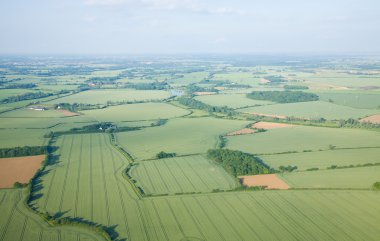 View over the early summer green fields from hot air balloon; East Anglia; clipart