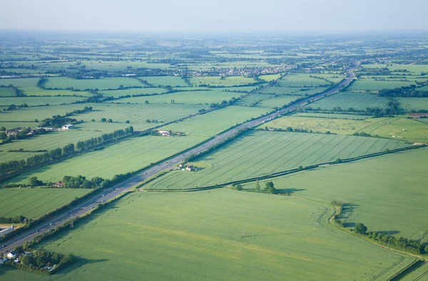 stock image View over the early summer green fields from the air