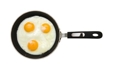 Three fried unbroken eggs on black non-stick frying pan; shot from the top; isolated clipart