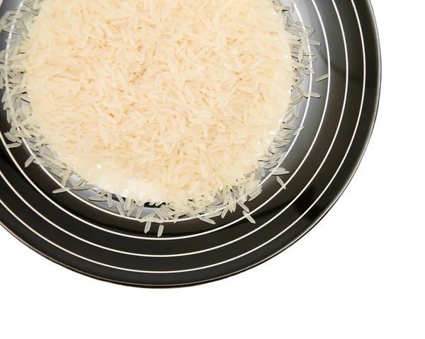 Arroz basmati fino de grano largo en un plato rayado blanco y negro ; — Foto de Stock