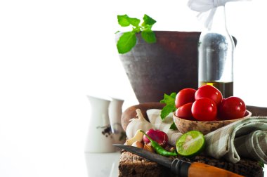 Fresh vegetables and olive oil on an old weathered wood with a o clipart