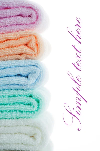 Multicolor towels stacked on white background with area for your — Stock Photo, Image