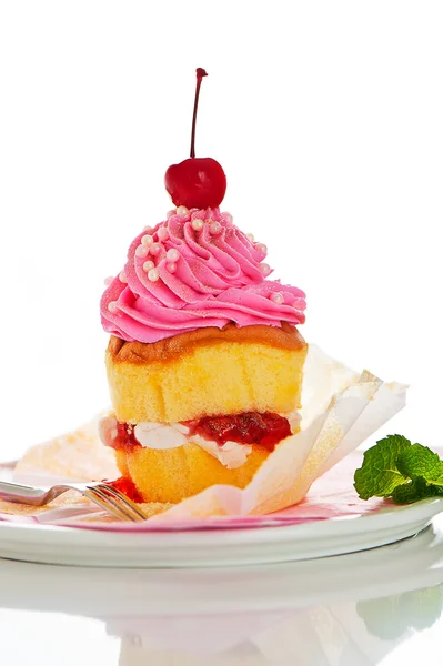 Een twee laag cupcake met roze en witte botterroom en goud pow — Stockfoto
