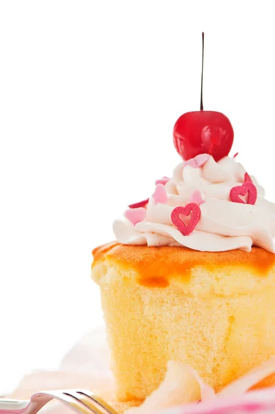 Vanilla cupcake with white cream heart as decoration and a cherr — Stock Photo, Image
