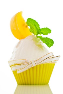 A refreshing lemon cupcake with a leaf of mint on white backgrou clipart