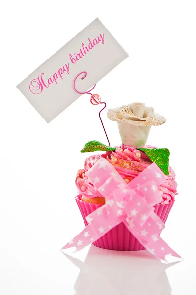 Un beau cupcake rose joyeux anniversaire avec une fleur et une étiquette — Photo