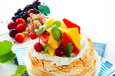 Pavlova with fresh fruit (mango, pineapple, watermelon, cherry) clipart