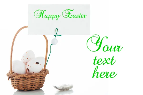 stock image A small basket with eggs and a label for your text on white bacx