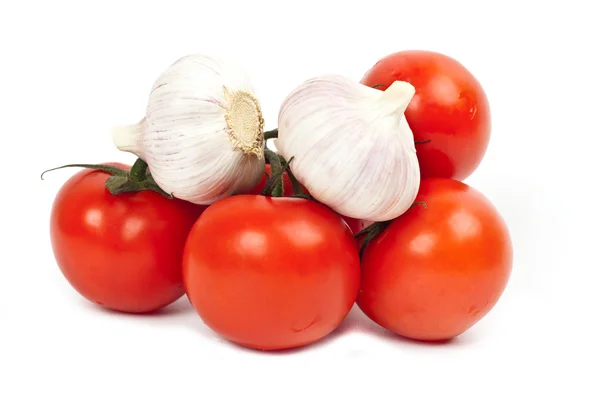 A lot of tomatoes and garlic — Stock Photo, Image