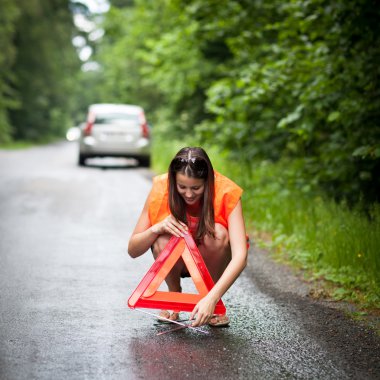 Young female driver after her car has broken down clipart