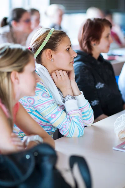 Νεαρή, όμορφη γυναίκα φοιτητής κάθεται σε μια σχολική τάξη — Φωτογραφία Αρχείου