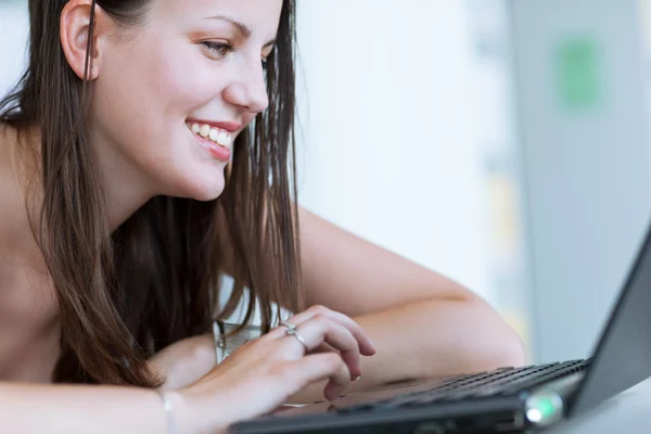 Pretty female college student studying in the university library Stock Image