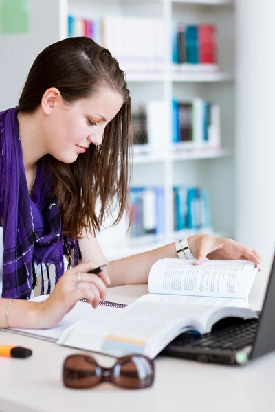 Estudante universitário muito feminino estudando na biblioteca da universidade — Fotografia de Stock