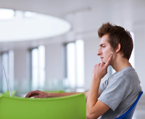 College student using his laptop computer — Stock Photo, Image