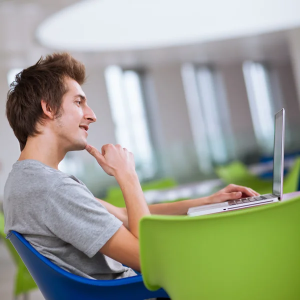 College student using his laptop computer — Stock Photo, Image