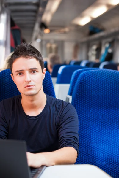Handsome young man using his laptop computer — Stock Photo, Image
