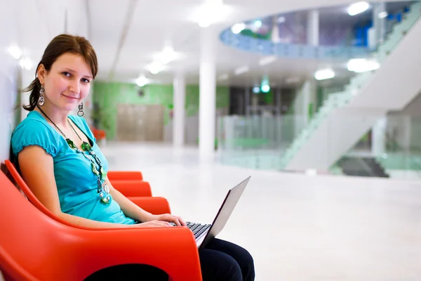 Pretty young female student with laptop — Stock Photo, Image