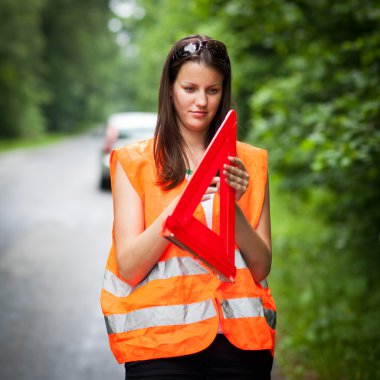 Young female driver after her car has broken down clipart