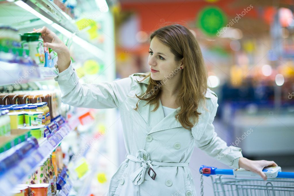 Beautiful young woman shopping in supermarket