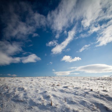 Snowy mountain scenery with deep blue sky clipart