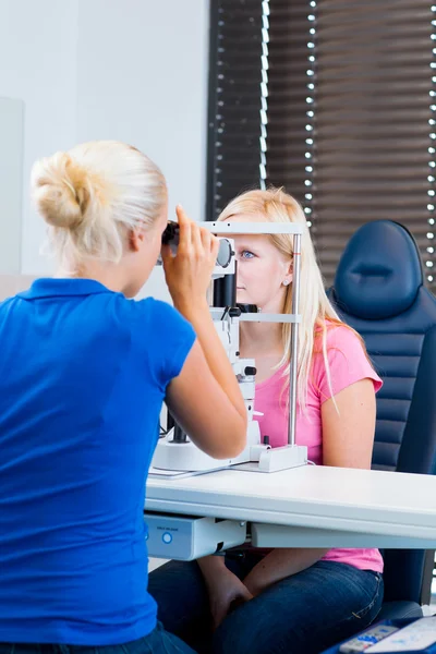 Mooie, jonge vrouwelijke patiënt met haar ogen onderzocht — Stockfoto