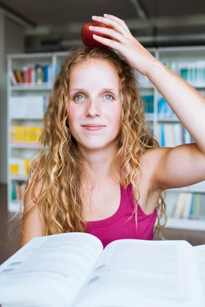 Estudante universitário muito feminino em uma biblioteca — Fotografia de Stock