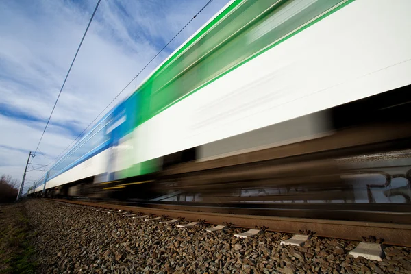 Fast train passing under a bridge on a lovely summer day — Stock Photo, Image