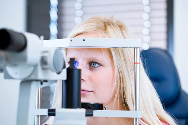 Pretty, young female patient having her eyes examined Stock Picture