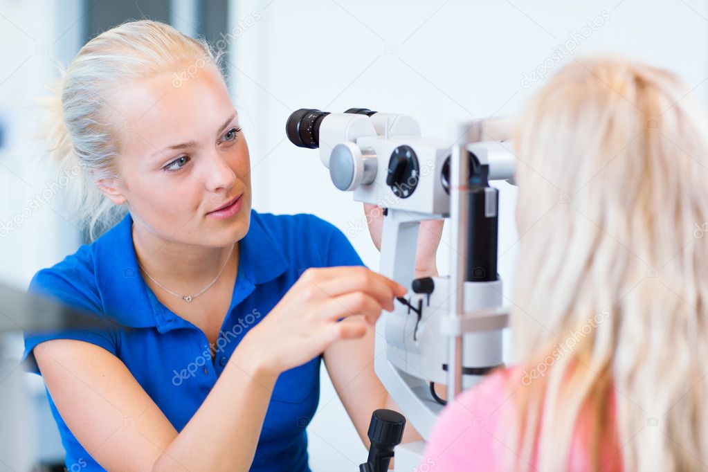 Pretty, young female patient having her eyes examined