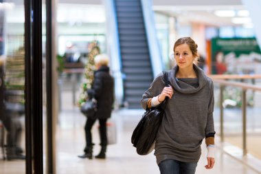 Young woman looking at store windows clipart