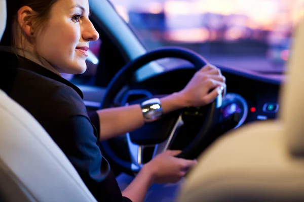 Woman driving his modern car at night in a city — Stock Photo, Image