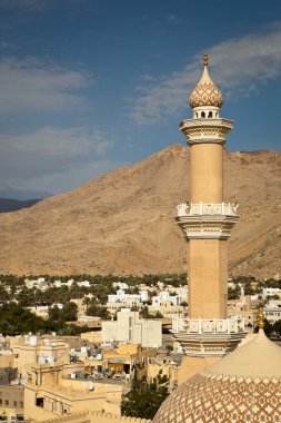 Stunning view of the city of Nizwa surrounded by mountains (Ad D clipart