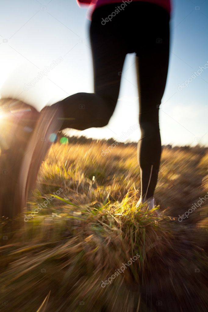 Young woman running outdoors on a lovely sunny winter/fall day