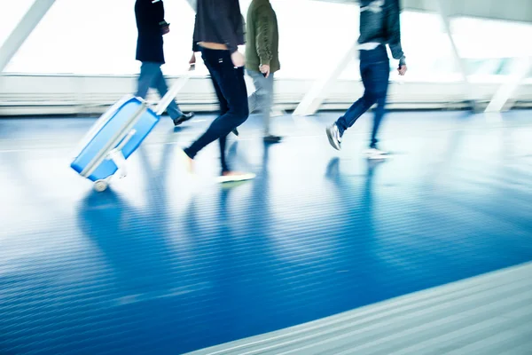 Med sina resväskor promenader längs en korridor — Stockfoto