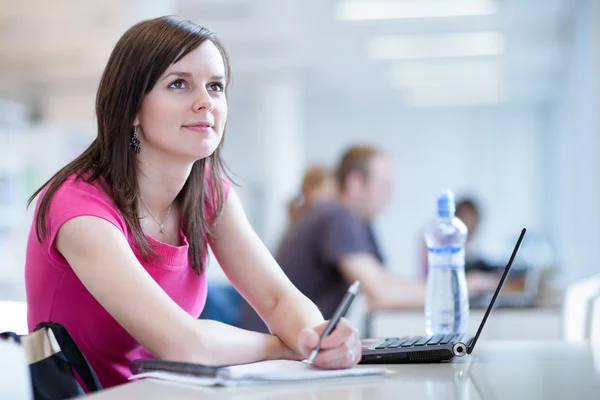 Pretty female student in the library — Stock Photo, Image