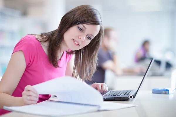 Pretty female student in the library Royalty Free Stock Images