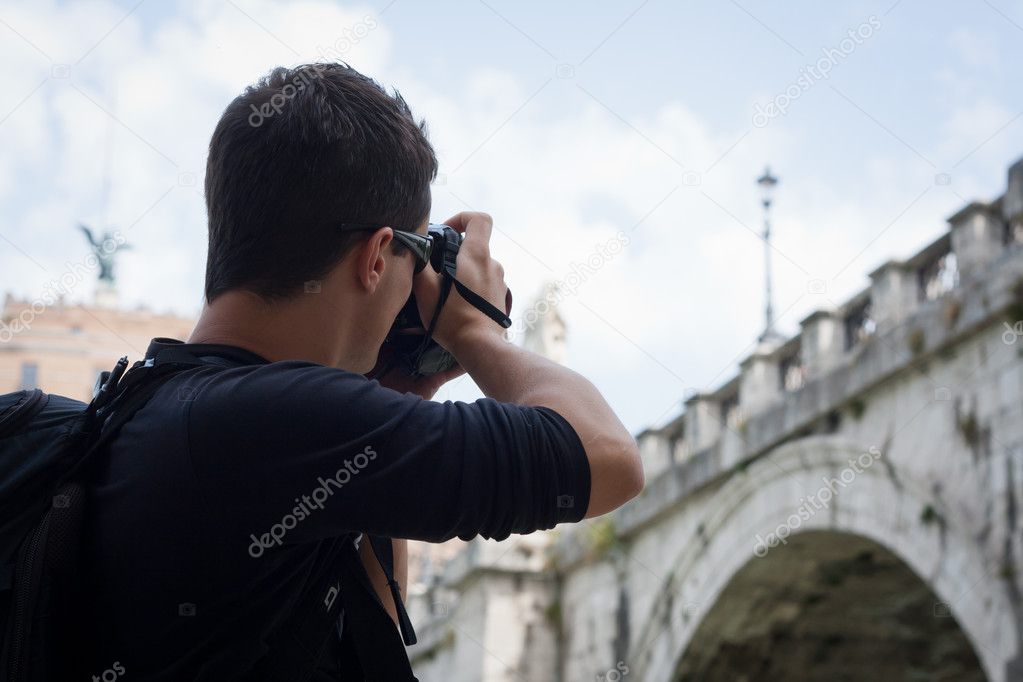 Young tourist taking photographs while sightseeing in Rome