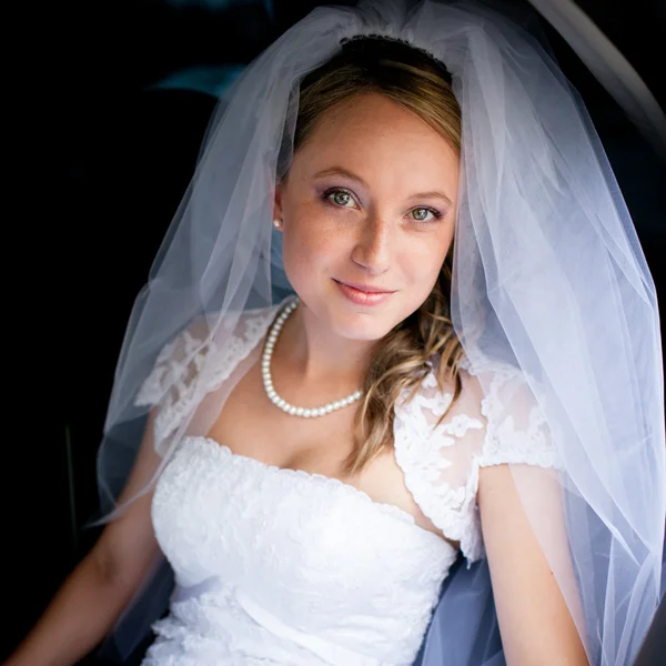 Retrato de una hermosa novia joven esperando en el coche — Foto de Stock