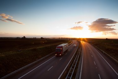 Highway traffic - motion blurred truck on a highway/motorway clipart