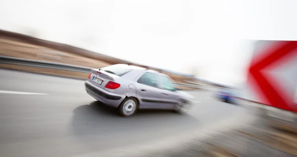 Traffic concept: car driving fast through a sharp turn — Stock Photo, Image