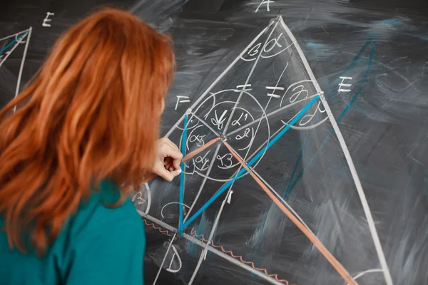 Pretty young college student writing on the chalkboard/blackboar — Stock Photo, Image