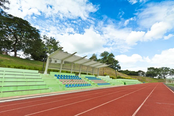 Stadium chairs and running track in a sports ground — Stock Photo, Image