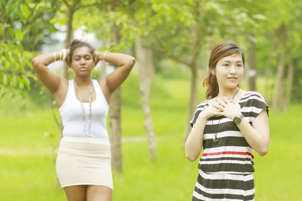 Two different races woman, black and asian. — Stock Photo, Image