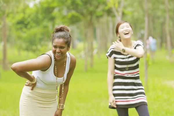 Two different races woman laughing, black and asian. — Stock Photo, Image
