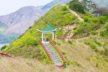 Hiking trail and pavilion in mountains clipart