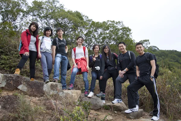 Asian hiking teams in mountains — Stock Photo, Image