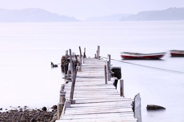 Sunset pier under long exposure, high key image. clipart