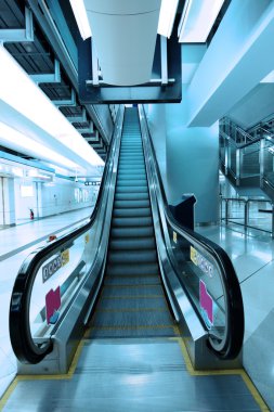 Moving escalator in subway station clipart