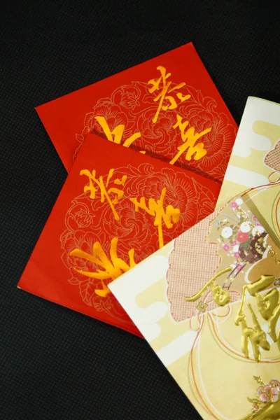 Red packets on black background — Stock Photo, Image